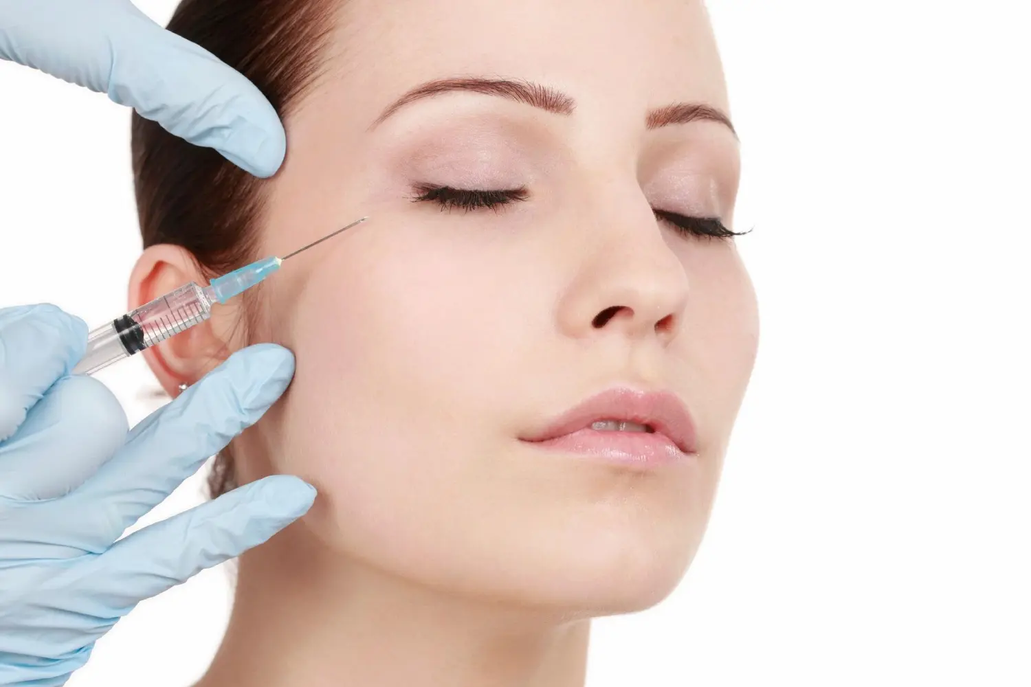 A woman getting an injection in her face.